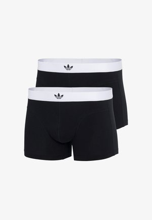 Boxer shorts noirs avec une ceinture élastique blanche portant un logo, fabriqués à partir d'un tissu lisse et extensible, épousant étroitement le corps.
