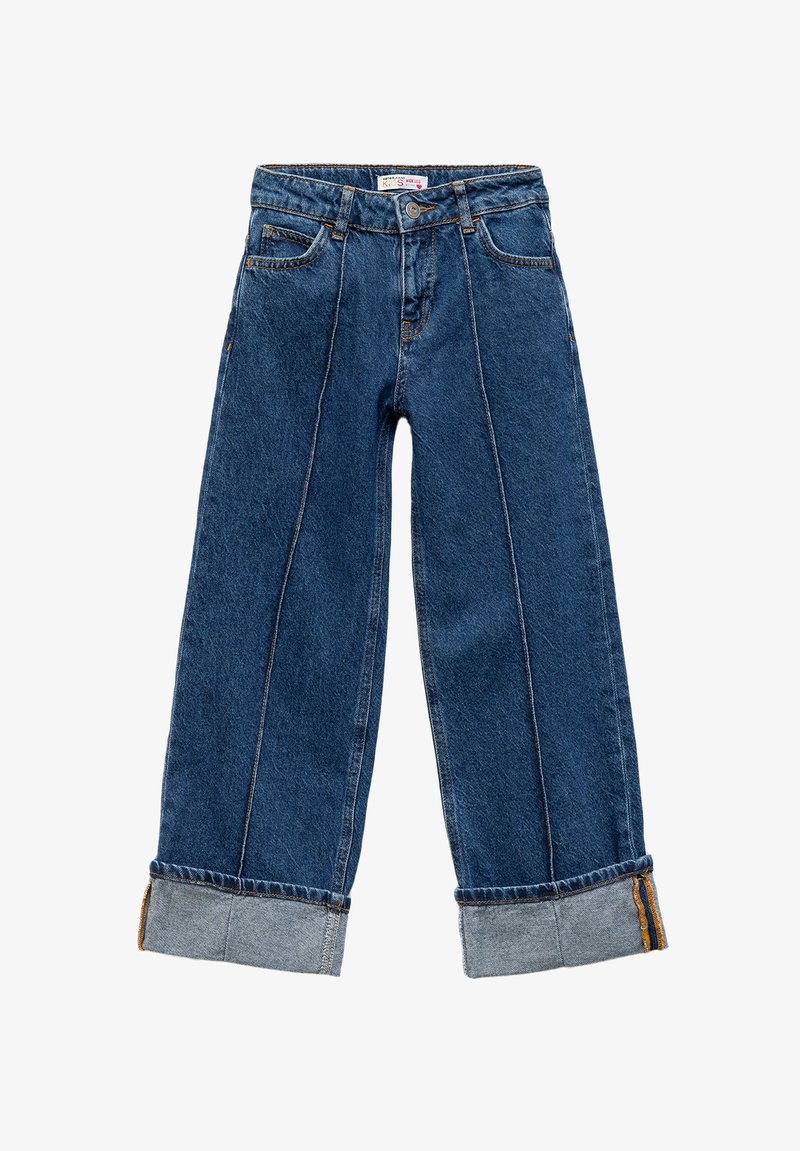 Lautir jeans leluasa dalam warna biru gelap, dengan pinggang tinggi, hem yang dibungkus, saku depan, dan aksen jahitan oranye di sepanjang jahitan.