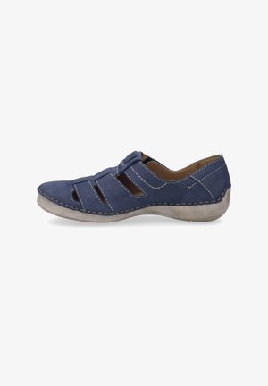Navy blue leather shoe with cutouts, rounded toe, and beige stitching. Low, textured sole. Minimalist design with adjustable strap.