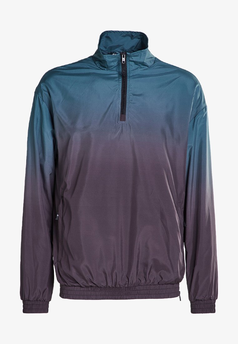 Herre pullover-jakke i gradient blå til mørk lilla. Laget av lett materiale, med en kvart glidelås, høy krage og elastisk kant.