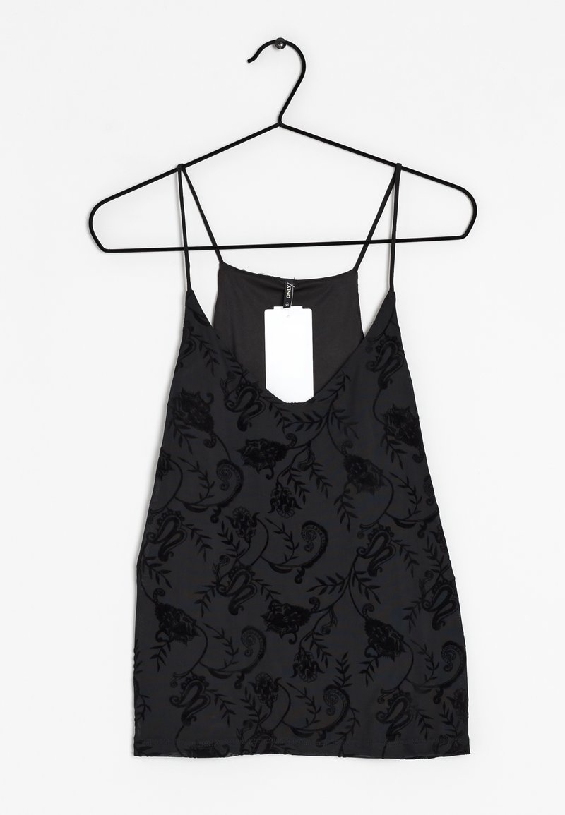 Haut noir sans manches à fines bretelles avec un motif floral en velours, suspendu à un cintre noir avec une étiquette blanche.