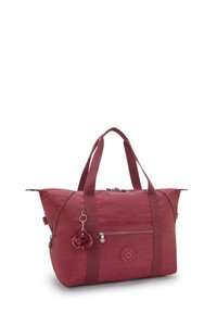 Bordowa nylonowa torba tote Kipling z podwójnymi uchwytami, przednią kieszenią na zamek, bocznymi zamkami oraz małym breloczkiem w kształcie małpki.