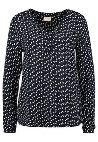 Blouse à manches longues bleu marine avec motif de petits cœurs blancs et encolure en V.