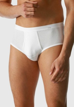 White cotton briefs featuring a smooth texture, elastic waistband, and a snug fit, accentuating the contours of the wearer's leg and body.