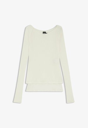 Pitkähihainen toppi kermanvärisenä, jossa pyöreä pääntie, kerrostettu helma ja pehmeä, kevyt kangas, jolla on sileä pinta.