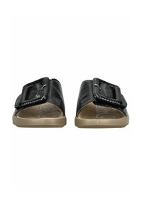 Black slide sandals with a textured upper, wide strap, and adjustable buckle. Beige rubber sole with slight arch support and minimal print.