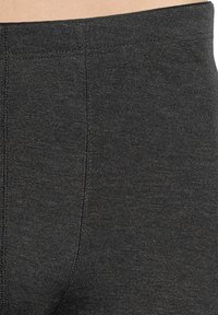Leggings noirs taille haute en tissu extensible texturé. Dotés de coutures renforcées et d'une taille sans coutures.