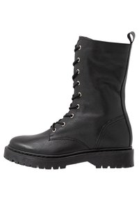 Svarta läder snörstövlar med rund tå, texturiserad ovandel, gummisula och metallöglor. Har en dragsko på baksidan.