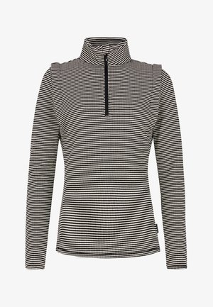 Pullover nero e bianco con collo alto e chiusura con zip, caratterizzato da un motivo a Houndstooth. Maniche lunghe e design aderente. Tessuto morbido.