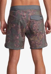Men's swim shorts made of fabric with a muted multicolor pattern, featuring a back pocket and a gray waistband. Textured surface, above the knee length.