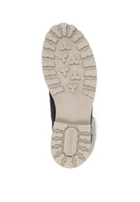 Black shoe with a textured rubber sole featuring deep treads and a raised logo. The insole has a light, fuzzy material for comfort.