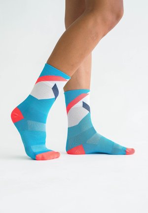 Blue and white patterned socks with coral accents and geometric design; mid-calf length, made from a smooth, stretchy material.