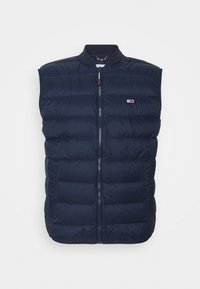 Chaleco acolchado de color marino con cuello alto, cremallera frontal y diseño sin mangas. Presenta un pequeño logo y un acabado texturizado.