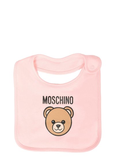 Vaaleanpunainen ruokaliina pehmeästä kankaasta, jossa on ruskean karhun graafinen kuva ja "MOSCHINO"-teksti karhun kasvojen yläpuolella. Yksinkertainen muotoilu, jossa on painonappikiinnitys.