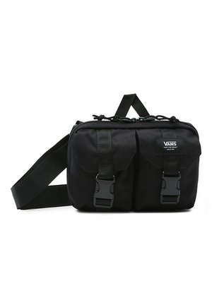 Riñonera negra de Vans con dos bolsillos frontales de hebilla, correa ajustable y asa superior, diseñada para llevar las manos libres.