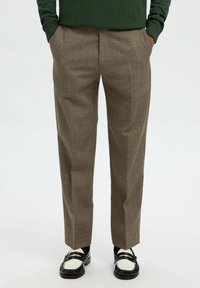 Beige ternede bukser med lige ben-design, lavet af et letvægtsstof, med forlommer og en fold ned foran.