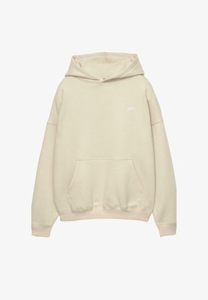 Cremefarvet hættebluse med en frontlomme, ribbede manchetter og kant, samt et lille hvidt logo på brystet. Fremstillet af blødt, tekstureret bomuldsstof.