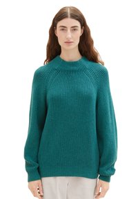 Türkis gestrickter Pullover mit gerippter Textur, hohem Kragen und langen Ärmeln. Verfügt über leicht raglanschnittige Schultern und einen lockeren Schnitt.
