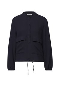 Top a maniche lunghe blu navy con colletto alto, bottoni frontali, due tasche sul petto e orlo con cordino. Tessuto con texture e vestibilità comoda.