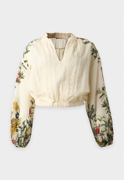 Blouse crème à manches longues ballon avec un imprimé floral multicolore et des détails en dentelle sur le devant, ourlet élastique et encolure froncée.