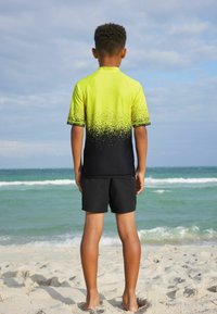 Next SHORT SLEEVE SUNSAFE  - Surfshirt - yellow black