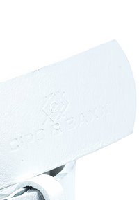 White leather sandal featuring an embossed logo, a smooth surface, and a simple strap design, suitable for casual wear.