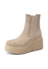 Stivale alla caviglia in suede beige con punta rotonda e pannelli laterali elasticizzati. Presenta una suola platform spessa e di colore chiaro per un'altezza aggiuntiva.