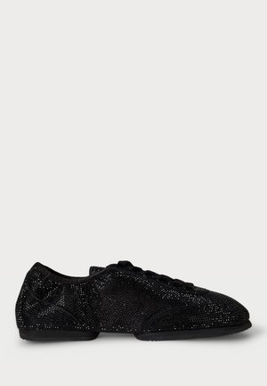 Scarpe nere piatte coperte di materiale scintillante, con punta arrotondata, design con lacci e fodera in tessuto morbido. Suola liscia e battistrada minimo.
