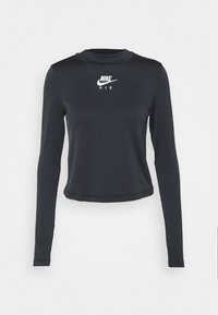 Svart ribbad långärmad crop top med rund halsringning. Har vit "Nike Air"-logga centrerad på bröstet. Slät textur.