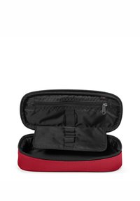 Red zippered case with a black interior. Features a mesh pocket, elastic bands for organization, and a smooth fabric texture.