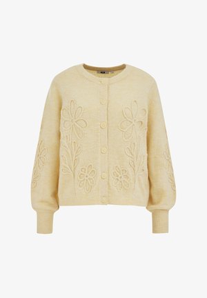 Roomkleurig gebreid vest met knopen aan de voorkant en verhoogde geborduurde bloemen op de borst en mouwen, met geribbelde boorden en zoom.