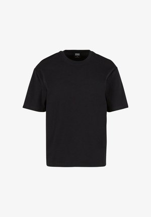 T-shirt noir à manches courtes en coton doux. Encolure classique et coupe décontractée, sans motifs ni détails en métal visibles.