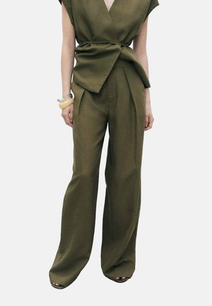 Olive green, loose-fitting top with a v-neck and tied waist, paired with high-waisted, wide-leg pants in matching material.