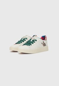 White sneakers with green laces, featuring a smooth texture and floral-patterned lining. Rounded toe and textured rubber sole.
