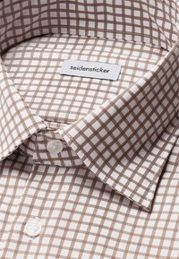 Camicia a quadri marrone e bianca con colletto button-down, dotata di etichetta cucita "seidensticker" e superficie in tessuto liscia.