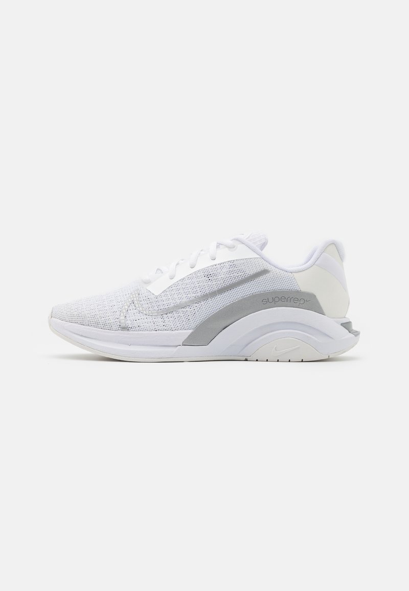 White athletic shoe with a textured mesh upper, gray accents, and a cushioned, curved sole. Features laces and a padded heel for support.