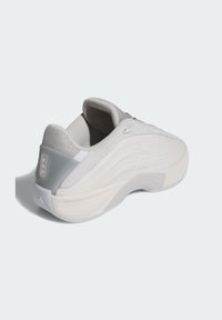 Gray athletic shoe featuring a textured upper, smooth midsole, and subtle perforations on the side. Includes a cushioned collar for comfort.