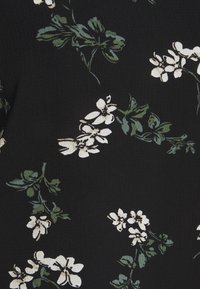Black fabric with a textured surface featuring a floral pattern of white flowers and green leaves in varying arrangements.