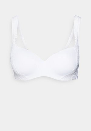 Reggiseno bianco con un design in tessuto liscio. Caratterizzato da coppe morbide, dettagli in pizzo sui lati e spalline regolabili. Forma classica e senza cuciture.