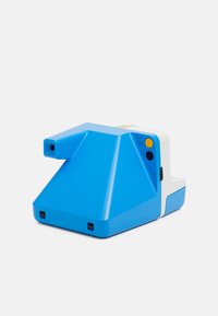 Blue plastic instant camera with a geometric design. Features a white accent, rectangular lens, power button, and USB port.