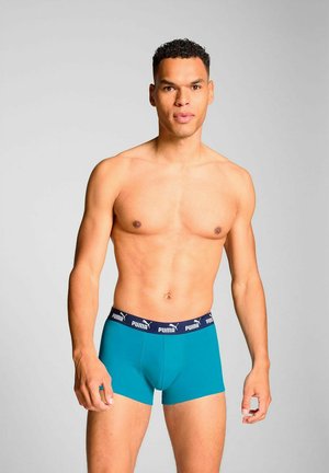 Men's turquoise boxer briefs with a navy waistband displaying a logo. The design is fitted with a smooth, stretchy fabric for comfort.