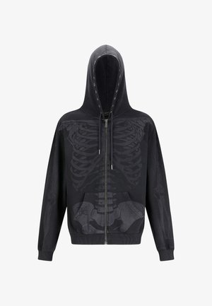 Zwarte zip-up hoodie met een gedetailleerde skeletafdruk op de voorkant. Het heeft een capuchon, voorzakken en een elastische zoom.