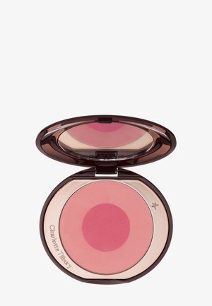 Compact avec un couvercle ouvert montrant deux teintes de blush rose à l'intérieur et un miroir sur le couvercle supérieur reflétant le produit.