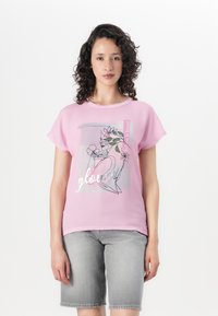 Pink short-sleeve T-shirt featuring a graphic design with floral accents, and the text "Believe in yourself" in silver lettering.