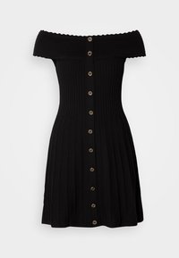 Robe noire à épaules dénudées en maille côtelée avec fermeture à boutons sur le devant et jupe évasée, ornée de boutons ronds métalliques décoratifs.