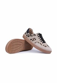 Paire de baskets en daim beige avec lacets noirs et accents imprimé léopard, une chaussure montrant une semelle en caoutchouc à motif quadrillé.