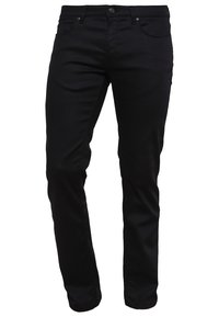 Mustat denim-housut kapealla istuvuudella. Niissä on viisi taskua, napillinen kiinnitys sekä sileä pinta. Saumoissa näkyvät ompelusaumat.