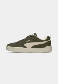 Green suede sneaker featuring a beige PUMA logo accent, white textured sole, and rounded toe. Includes matching laces and back pull tab.