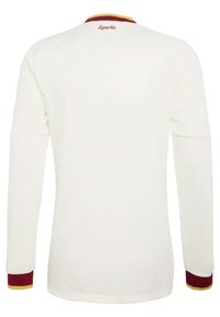 Camisa blanca de manga larga con puños rojos y amarillos, "España" bordado en rojo en la parte trasera del cuello.