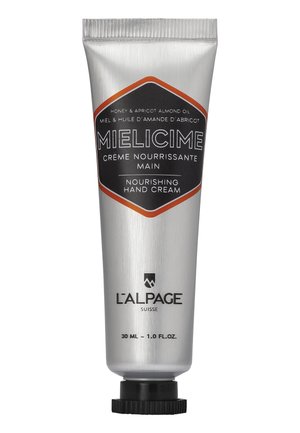 Aluminiumtube mit Handcreme; silber mit schwarzen und orangefarbenen Akzenten. Der Text lautet "nährende Handcreme" und listet die wichtigsten Inhaltsstoffe auf. 30 ml Größe.